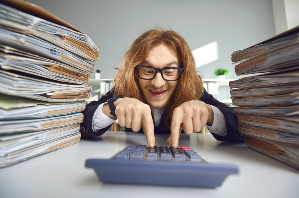 A whacky looking man excitedly trying to save on taxes by filing his piles of returns early and enthusiastically.