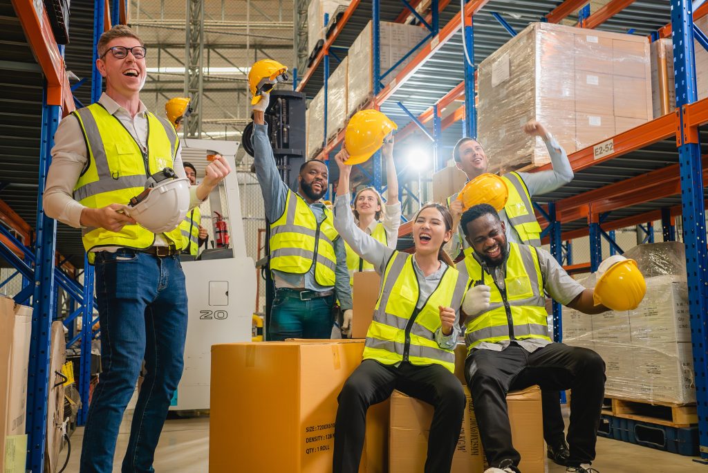 A group of employees and the owner celebrating a commercial loan from a credit union